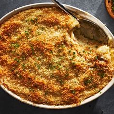 a casserole dish with cheese and parmesan bread on the side, ready to be eaten