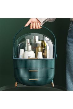 a person holding a green container filled with personal care items