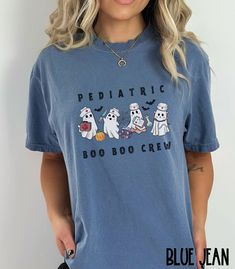 This Pediatric Nurse Boo Boo Crew Comfort Colors Halloween shirt makes the perfect Fall shirt for work or play! Cute and trendy, it will be sure to be a favorite! ♥ W E L C O M E  T O  S K E T C H Y  C A T  D E S I G N S ! ♥ * This is a standard unisex garment-dyed 100% cotton shirt - Comfort Colors Tee with a relaxed fit. FOR AND OVERSIZED TEE, PLEASE SIZE UP!!  Please review the size chart to ensure you receive the fit you want. ♥ Click here to return to our shop's home page ⇒  https://www.ets Picu Nurse Shirt, Nurse Halloween Ideas, Halloween Blue Tops With Letter Print, Blue Halloween Top With Letter Print, Blue Halloween Tops With Letter Print, Blue Letter Print Top For Halloween, Blue Halloween Letter Print Tops, Casual Fall Shirt With Cartoon Print, Blue Pre-shrunk Tops For Halloween