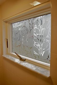 a bathroom window with frosted glass behind it