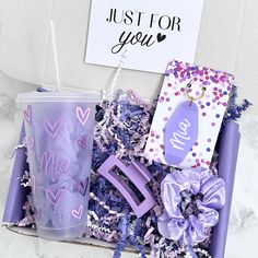 a purple gift box filled with personalized items and a note that says just for you