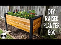 a wooden planter box with plants in it and the words diy raised planter box