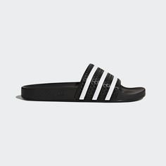 Style No. 280647 Color: Core Black / White / Core Black The Adilette debuted in 1970 before being officially released back in '72. It's been a style mainstay of adidas ever since. These slides stay true to the original look with a contoured footbed and 3-Stripes across the bandage upper. Regular fit. Slip-on design. PU-coated synthetic bandage upper. Quick-dry lining. Contoured footbed. Polyurethane outsole. adidas Originals Men's Core Black & White adilette Slides. Sneaker Shop, Adidas Slides, Black Slides, Sneaker Sale, Adidas Adilette, Mens Slides, Adidas Originals Mens, Heritage Fashion, Adidas Samba Sneakers