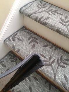 a carpeted stair case with leaves on it