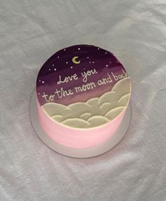 a cake that is sitting on top of a table with the words love you to the moon and back