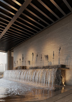 a large waterfall in the middle of a building with lots of water coming out of it