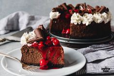 a slice of chocolate cheesecake with cherries and whipped cream