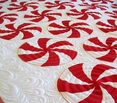 red and white quilted bedspread with circular designs on it's edges