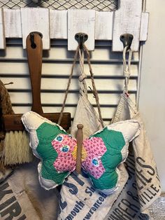 two butterfly shaped pillows hanging from hooks