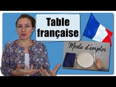 a woman standing in front of a table with french flags and other items on it