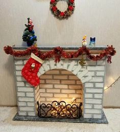 a fireplace decorated for christmas with stockings and ornaments