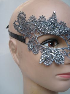 * This stiff silver lace half mask has been designed with five pointed silver beaded stars which have been trimmed and stationed around each eye. Down the front of the mask four faceted crystals accent the shape of the nose. * To secure the mask there are two black satin ribbons on each side to be tied in the back. * A great piece for a Masked Ball, a Night at the Opera, Class Reunion, Birthday Celebration, Halloween, New Year's Celebrations, Parade or Festival, Costume party or Play, Carnivale, Silver Gothic Mask For Costume Party, Silver Gothic Mask For Masquerade, Gothic Silver Mask For Costume Party, Gothic Silver Mask For Masquerade, Silver Rhinestone Eye Mask For Masquerade, Silver Rhinestone Eye Masquerade Mask, Silver Gothic Eye Mask For Masquerade, Silver Gothic Eye Masquerade Mask, Gothic Silver Eye Masquerade Mask