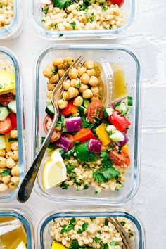 four plastic containers filled with different types of food including vegetables and chickpea salad