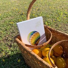 a basket filled with oranges and an open book