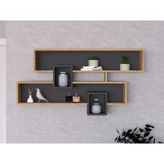 three wooden shelves on the wall with vases and other items in them for display