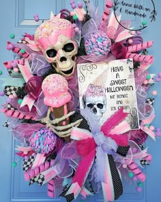 a pink and purple wreath with a skeleton on it