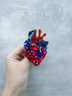 Check out this item in my Etsy shop https://www.etsy.com/listing/1267995954/embroidered-anatomical-heart-brooch Anatomical Heart Brooch, Heart Brooches Handmade, Organ Art, Blue Pomegranate, Embroidery Brooches, Leather Cord Jewelry, Clothes Embroidery Diy, Embroidered Brooch, Beadwork Embroidery