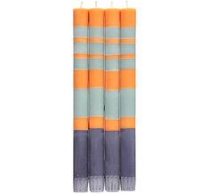 three orange and blue candles sitting on top of each other