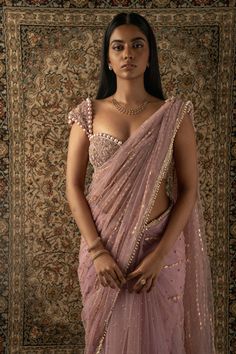 This dusty pink sari is a vision of elegance, crafted from net fabric that glimmers with every movement. Paired with a net blouse, the ensemble radiates sophistication and charm. The intricately hand-embroidered blouse adds a touch of glamour, making it perfect for a cocktail or reception, whether for the bride or her bridesmaids. With its timeless allure and delicate detailing, this sari is sure to captivate attention and leave a lasting impression on any special occasion. Pink Saree With Pink Blouse, Cocktail Saree Blouse, Blouse Designs On Silk Saree, Blouse For Wedding For Women, Blouse Design Aesthetic, Bridesmaid Saree Ideas, Pretty Sarees Beautiful, Saree Blouse Aesthetic, Saree Ideas For Bridesmaids