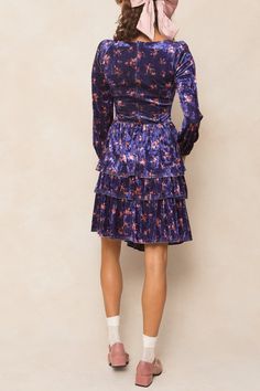 Introducing the Nikki Dress! This stunning knee-length dress features a gorgeous purple velvet fabric with pink florals throughout, giving it a romantic and luxurious feel. The sweetheart neckline and long flowy sleeves add a touch of elegance, while the hidden back zipper and elastic wrist closure make it easy and comfortable to wear. Perfect for any occasion (including the Eras Tour!). Purple Floral Print Knee-length Mini Dress, Purple Floral Dress For Party, Purple Velvet Fitted Dress, Purple Knee-length Winter Dress, Fitted Purple Velvet Dress, Purple Velvet Dress For Party, Purple Velvet Party Dress, Mini Velvet Dresses For Fall, Fitted Velvet Dresses With Floral Print