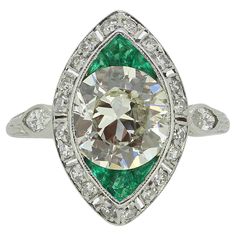 an art deco diamond and emerald ring