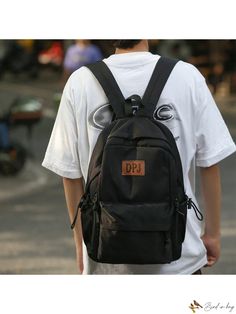 a young man wearing a black backpack and white t - shirt