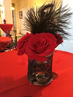 a vase filled with red roses on top of a table