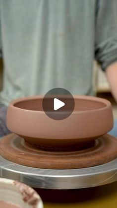 a person sitting at a table with a bowl on it