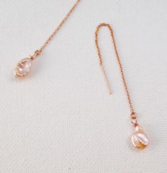 "Rose gold and pearl threaders. 3 1/2 inches of rose gold filled chain and organic blushing baroque pearls. Minimalism at its best! Threaders are so popular right now and work well with the new mix and match. Pearls are classic jewelry, yet go with everything! **Ships gift wrapped and insured to USA. If you see \"rose gold-filled,\" you can assume it is \"14k rose gold-filled\", rather than yellow gold.  The difference is just in the color, not in the quality or durability.  Both 14k yellow gold Dainty Rose Gold Threader Earrings For Gift, Dainty Rose Gold Long Drop Jewelry, Rose Gold Jewelry With Pearl Chain And Dangle, Rose Gold Pearl Jewelry With Delicate Chain, Rose Gold Dangle Threader Earrings With Delicate Chain, Adjustable Rose Gold Pearl Drop Jewelry, Feminine Rose Gold Pearl Drop Jewelry, Rose Gold Pearl Jewelry With Adjustable Chain, Dainty Rose Gold Pearl Drop Jewelry