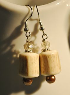 "Genuine polished deer antler beads mix with champagne crystals and brown pearls in these cute earrings. Show your love for hunting! Each pair will not be exactly the same as the antler beads are all a one of a kind natural product, but they will be very similar to the ones pictured.  Hypoallergenic ear wires Sterling silver ear wires may be substituted for $3.00 Purchase them from the sterling silver ear wires section in my shop and I will assemble for you before I ship. Drop: approx. 2\"  5.08 cm Your earrings will be carefully placed in a box with cotton insert and mailed in a bubble mailer. To see more Beechtree earrings, please view: https://www.etsy.com/shop/Beechtree?section_id=11927776" Antler Mounts, Antler Beads, Lost Wax Jewelry, Brown Pearls, Antler Ideas