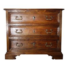 an old wooden chest of drawers with brass handles