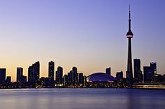 the city skyline is lit up at night