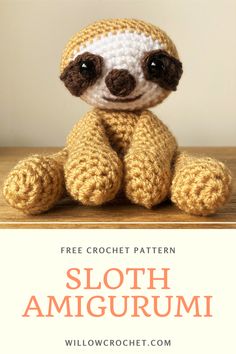 a crocheted sloth amigurmi sitting on top of a wooden table