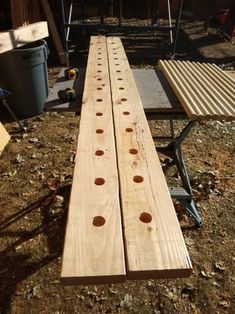 two pieces of wood sitting next to each other on the ground in front of a building