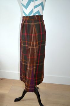 This is a great vintage skirt from the 1950s. It appears to have been handmade due to hand stitching inside the skirt, and there are no labels. Made of wool plaid fabric and lined with polyester. Plaid is rich in fall hues of browns, purple, hunter green, and red. Perfect for the holiday season and winter. It appears to fit a small- see measurements below.waist- 25"hip- 44"length- 29" Plaid Wool Skirt, Wool Skirt, Brown Plaid, Plaid Fabric, Green And Red, Wool Skirts, Wool Plaid, Hunter Green, Vintage Skirt