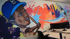 an office with large murals on the wall and desks