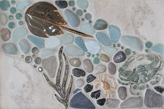 a mosaic with sea glass and shells on it