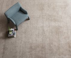 a blue chair sitting on top of a carpet covered floor