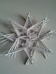 an origami snowflake made out of sticks