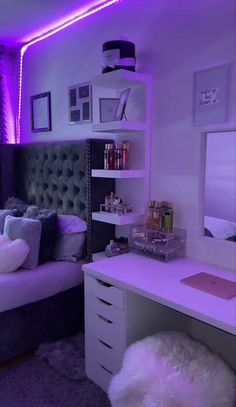 a bedroom with purple lighting in the ceiling and white fur rugs on the floor