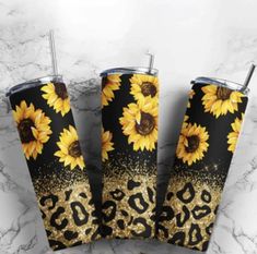 three sunflowers and leopard print tumbler cups on a marble countertop with gold glitter