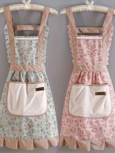 two aprons are hanging on the wall, one has a pocket for something else