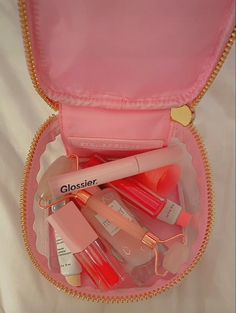 a pink case filled with lots of different types of lipstick and other items in it