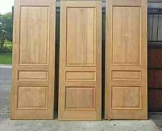 three wooden doors sitting next to each other