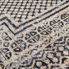 an old rug with black and white designs on it's edges, close up