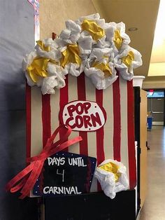 the popcorn machine is decorated with red, white and blue paper streamers that read pop corn days until carnival