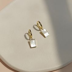 Add a touch of sophistication to any outfit with these fashionable square pendant earrings. Crafted with a sleek and modern design, they feature a delicate dangle that catches the light beautifully. Perfect for both casual and formal occasions, they will elevate any look with their chic and timeless style.Material: Metal. Luxury Rectangular Everyday Earrings, Elegant Everyday Earrings With Rectangular Pendant, Elegant Silver Rectangular Hoop Earrings, Chic Rectangular Earrings As Gift, Chic Rectangular Earrings For Gift, Modern White Rectangular Earrings, Modern Square Pendant Earrings As Gift, Modern Square Pendant Earrings For Gift, Chic Rectangular Everyday Earrings