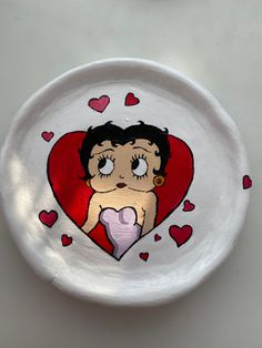 a white plate with a drawing of a girl on the side and hearts around it