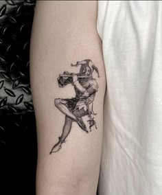 a man with a tattoo on his arm is holding a woman's leg in the air