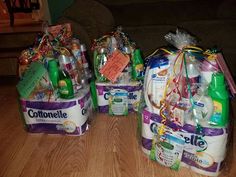 three bags filled with diapers sitting on top of a wooden floor